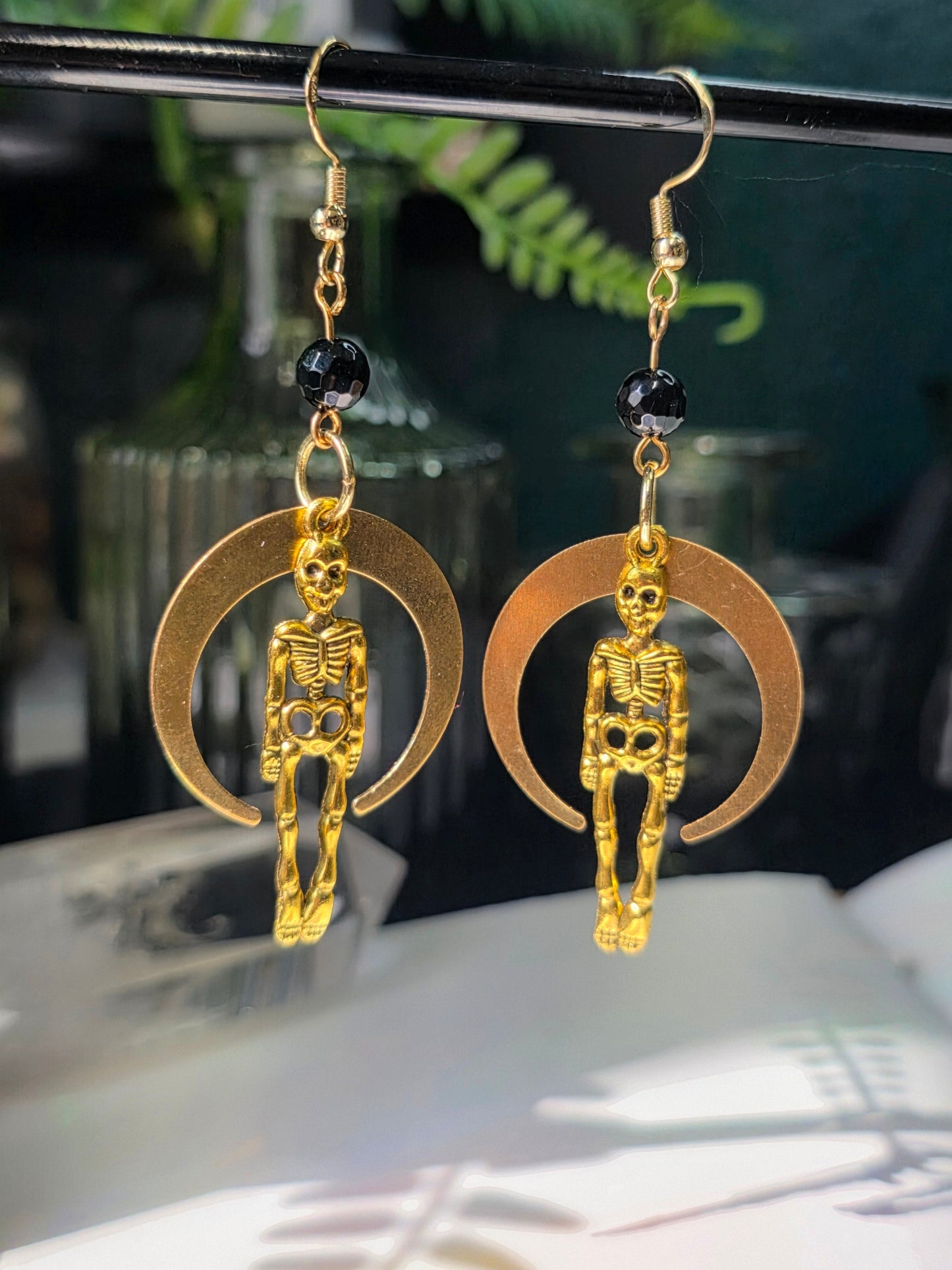 Skeletons and Downward Large Moon in Round Faceted Obsidian Danse Macabre