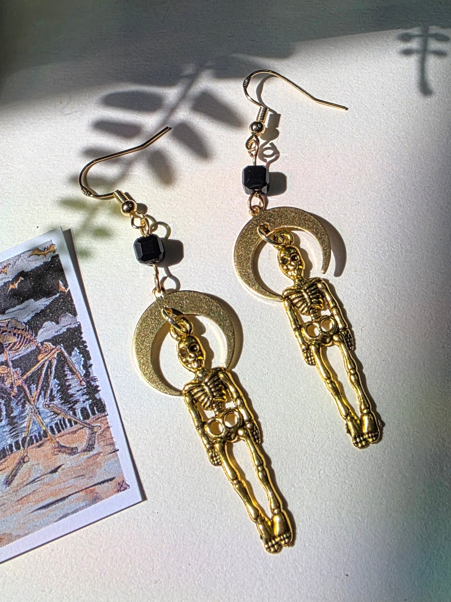 Skeletons and Downward Moon in Cubic Obsidian Danse Macabre
